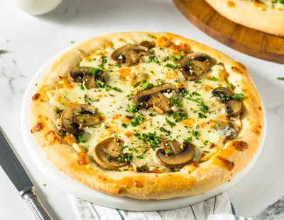 Freshly Baked Mushroom Pizza On A White Plate