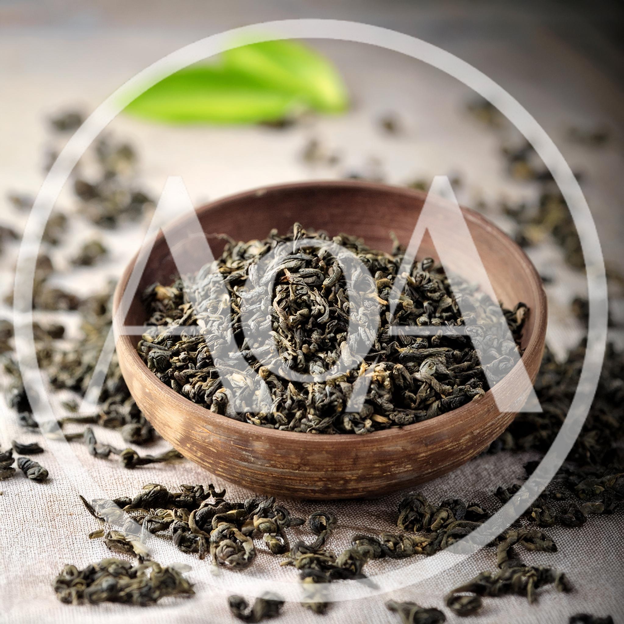 Dried Green Tea Leaves In A Rustic Clay Bowl