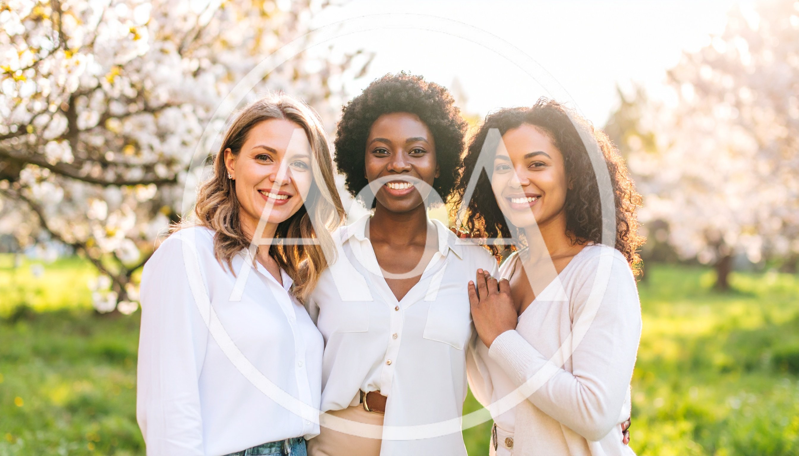 Three Diverse Women Smiling Together in a Spring Garden