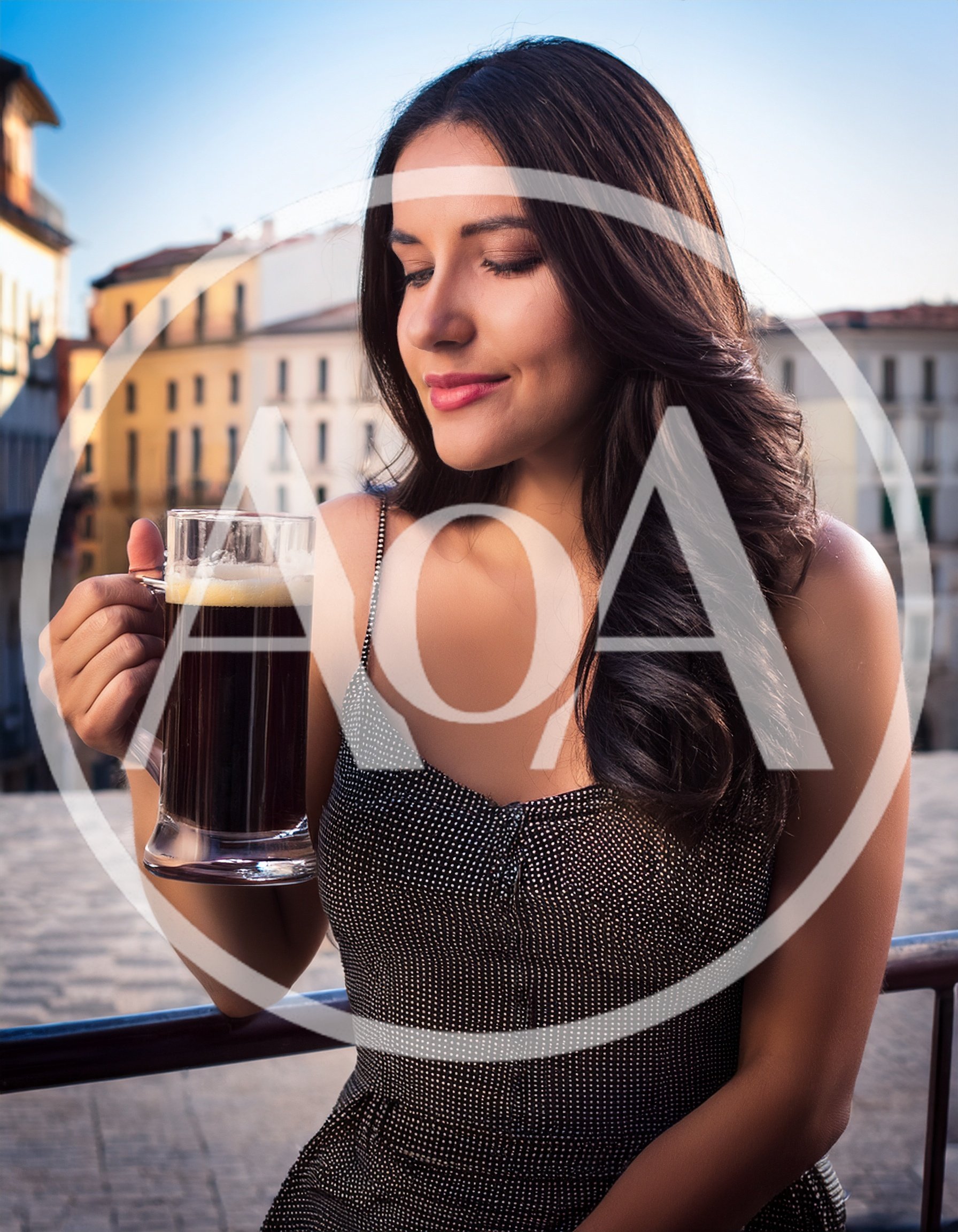Young Woman Enjoying Dark Beer on City Balcony