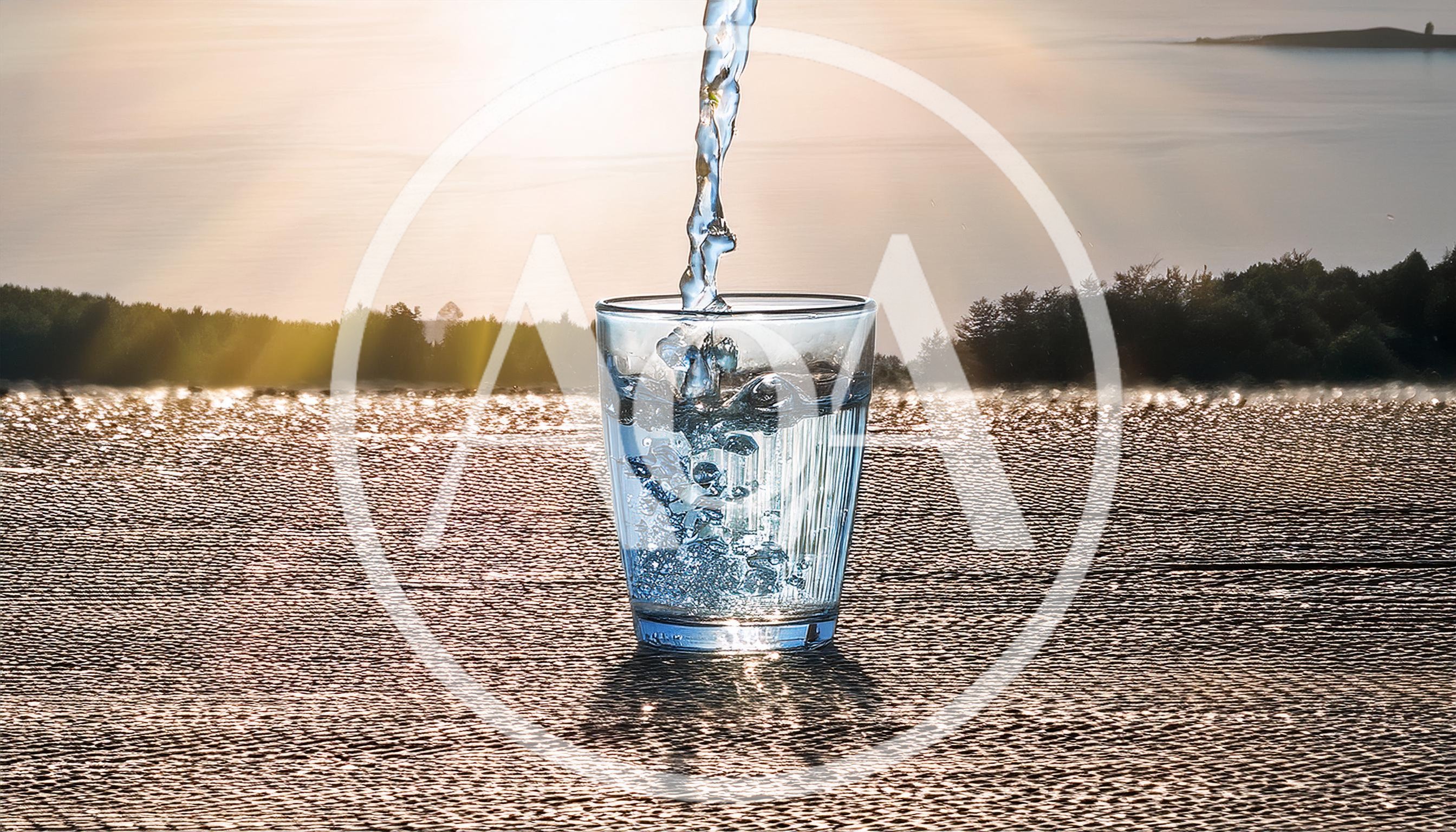 Water Pouring Into A Glass At Sunset