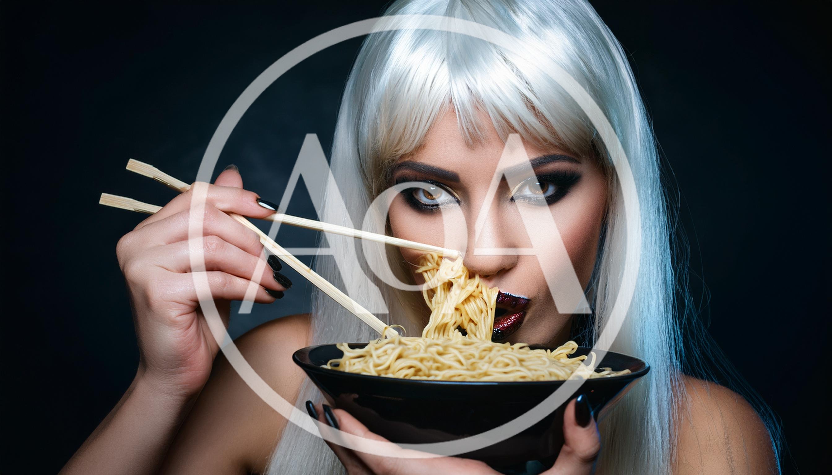 Woman With Platinum Blonde Hair Eating Noodles With Chopsticks
