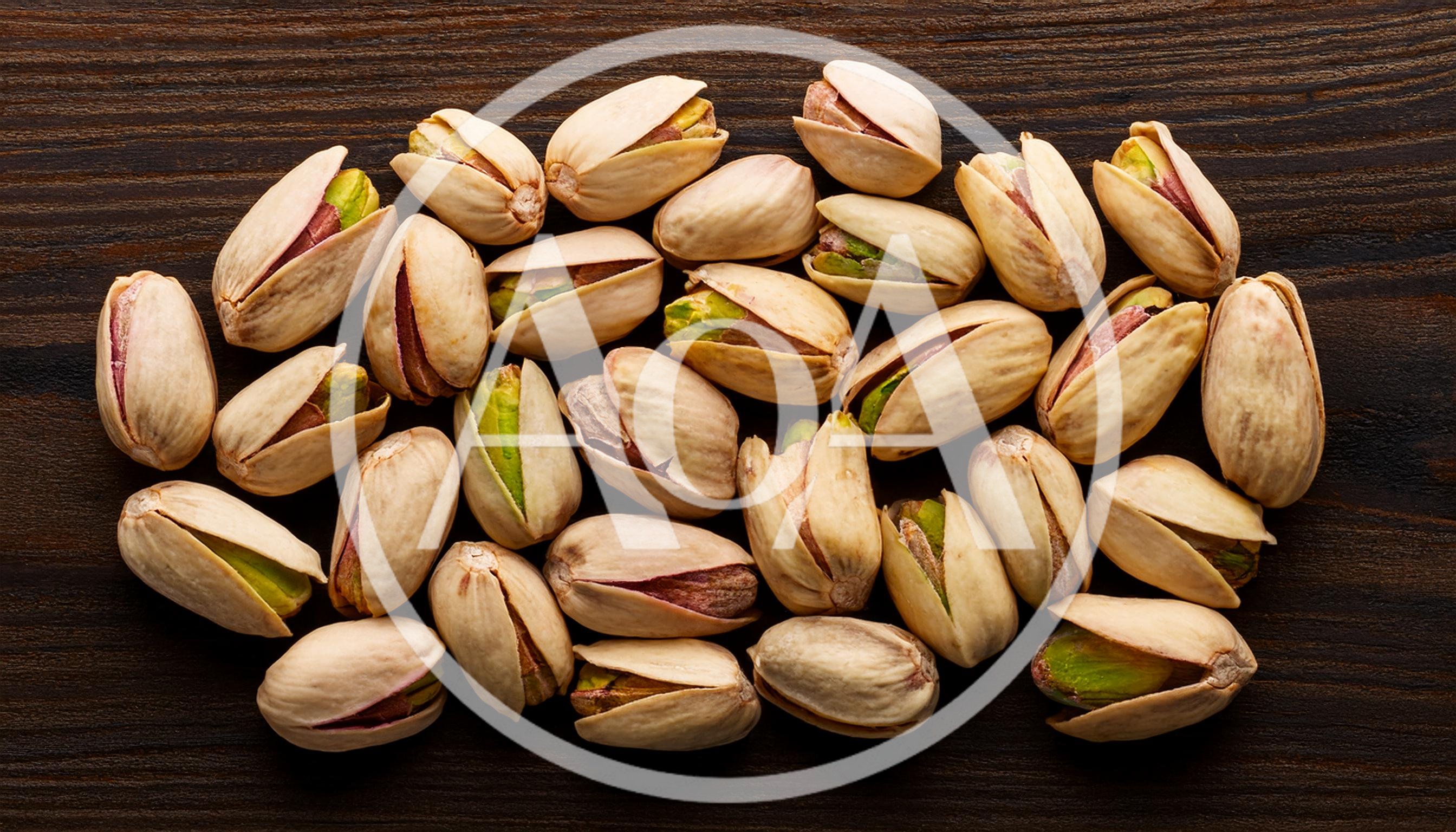 Top View Of Roasted Pistachios On Dark Wooden Surface