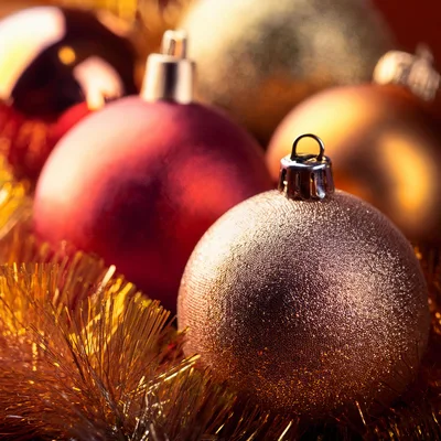 Festive Christmas Ornaments With Gold Tinsel Background