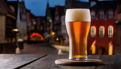 Cold Glass Of Beer On A Wooden Table
