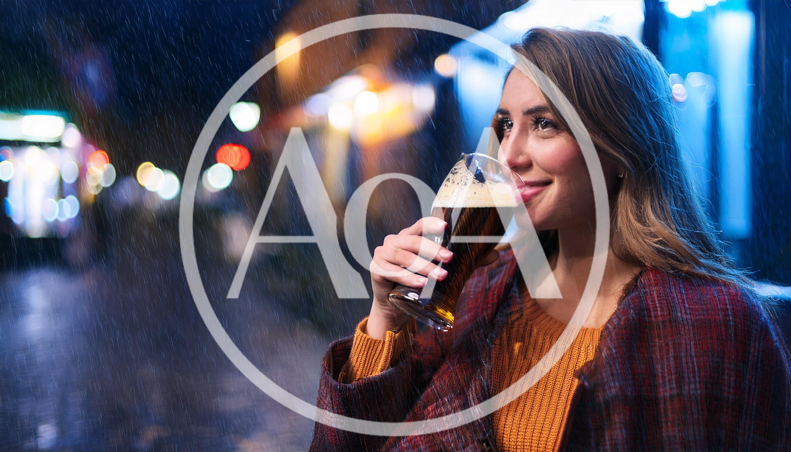 Young Woman Drinking Dark Beer Outdoors In The Rain