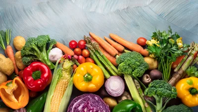Fresh Assorted Vegetables Arranged On A Blue Surface
