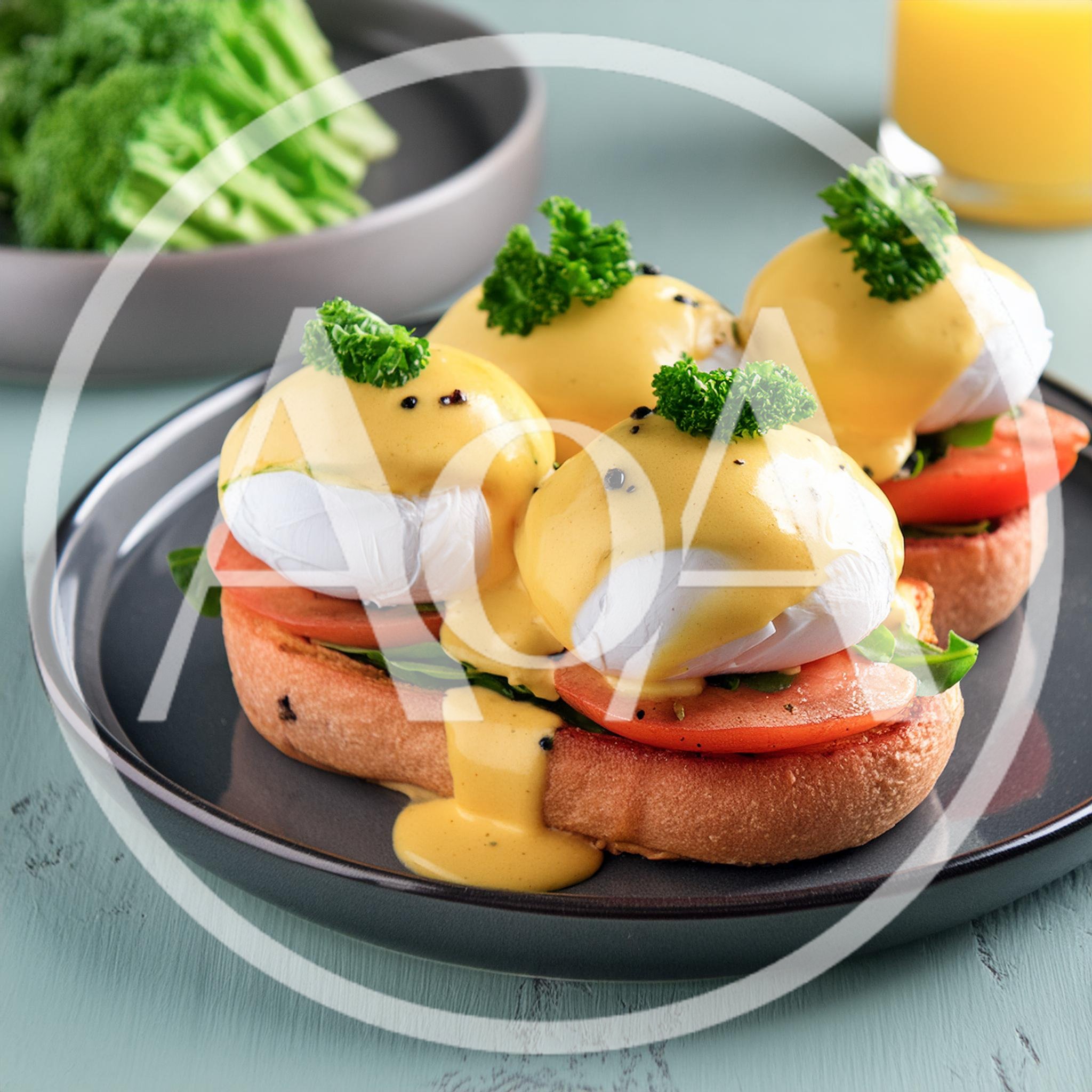 Gourmet Eggs Benedict With Tomato And Fresh Herbs