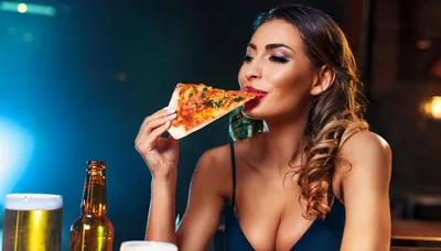 Beautiful Woman Eating Pizza Slice in a Bar