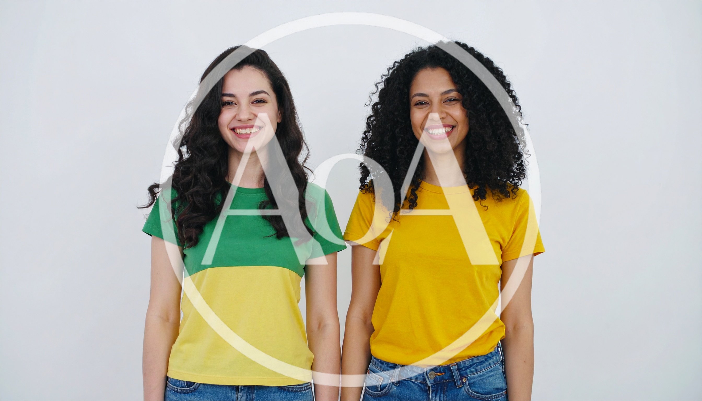 Two Diverse Women Smiling Together Against White Background