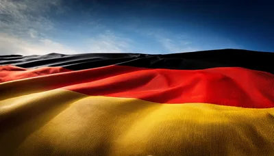 Waving German Flag Against A Clear Blue Sky