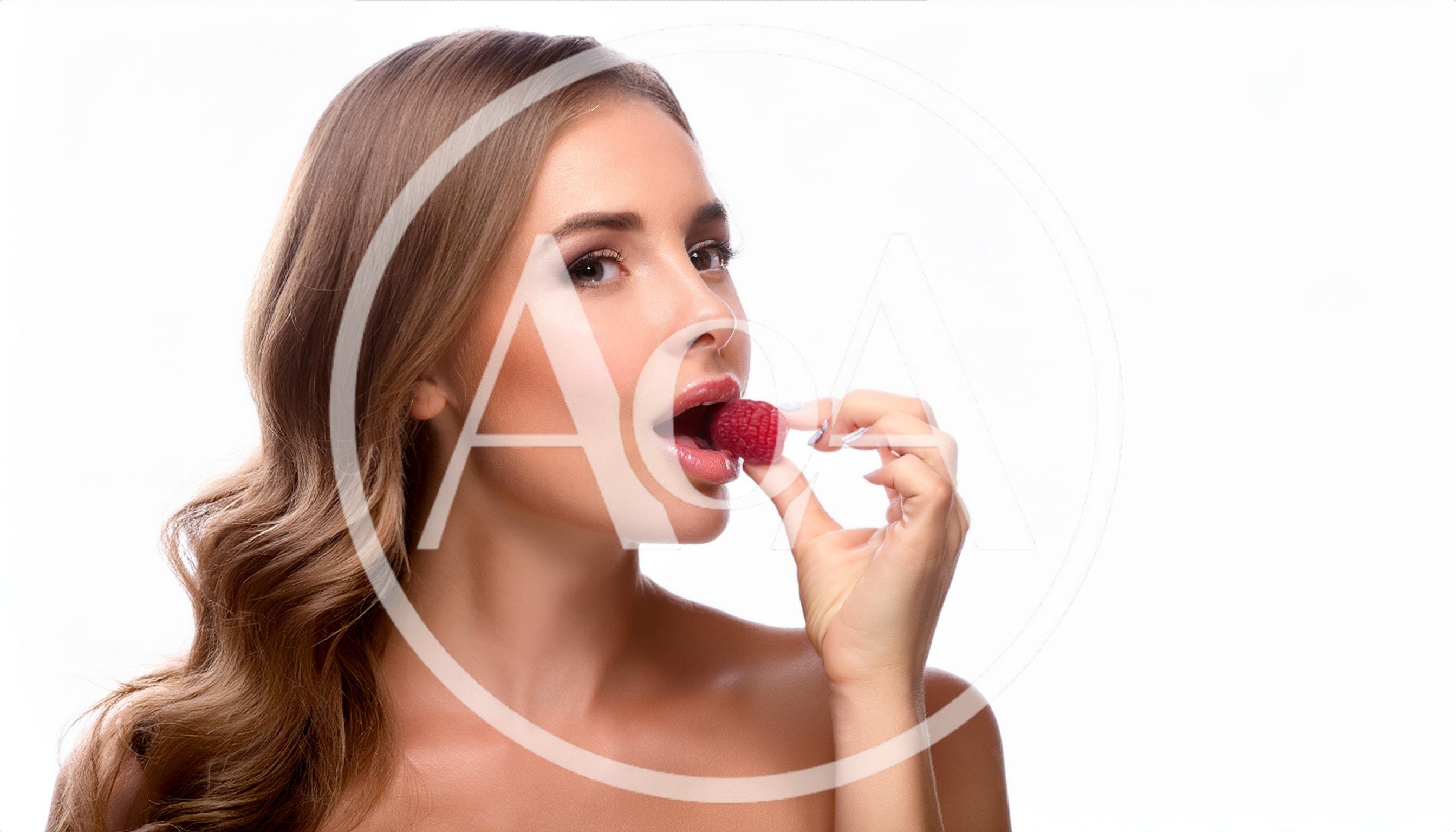 Beautiful Woman Eating A Fresh Raspberry