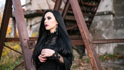Gothic Woman Standing Near Rusty Industrial Structure