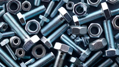Assorted Metal Bolts and Nuts on Dark Background
