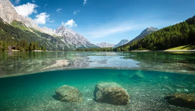 Split Level View Of Alpine Lake And Mountains