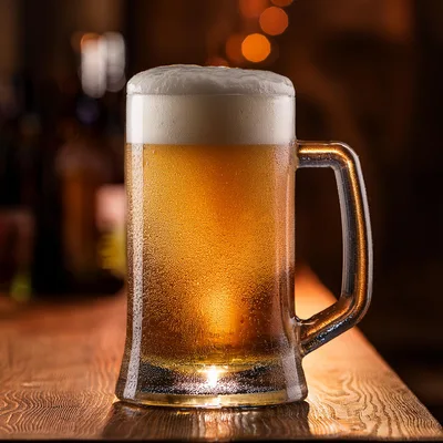 Cold Frothy Beer Mug On A Wooden Bar Counter