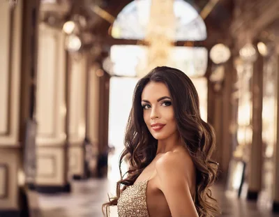 Elegant Woman In Gold Sequin Dress In Luxury Hallway