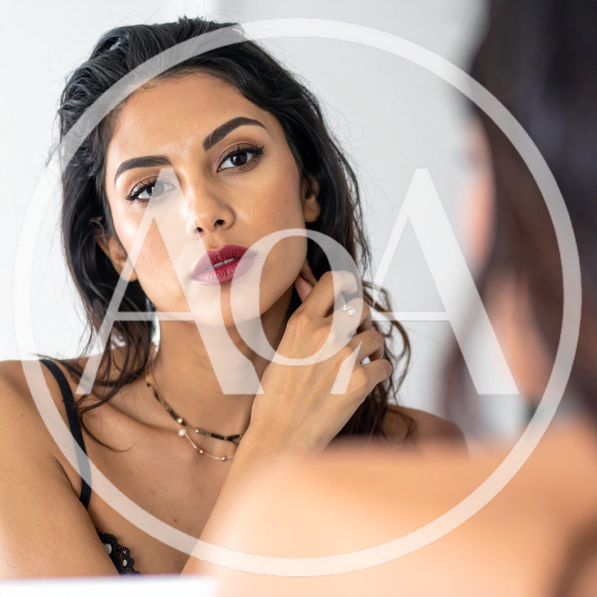 Woman Looking At Her Reflection In A Mirror