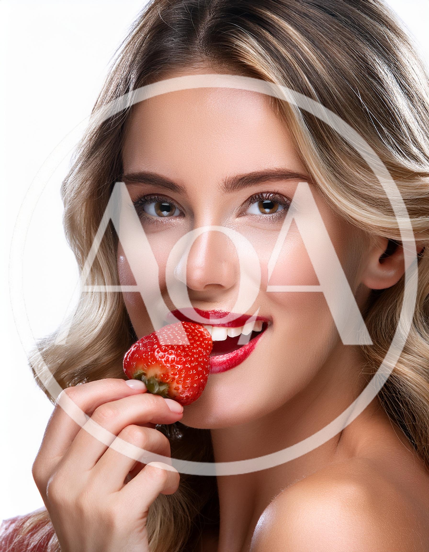 Beautiful Woman Holding A Fresh Strawberry To Her Lips