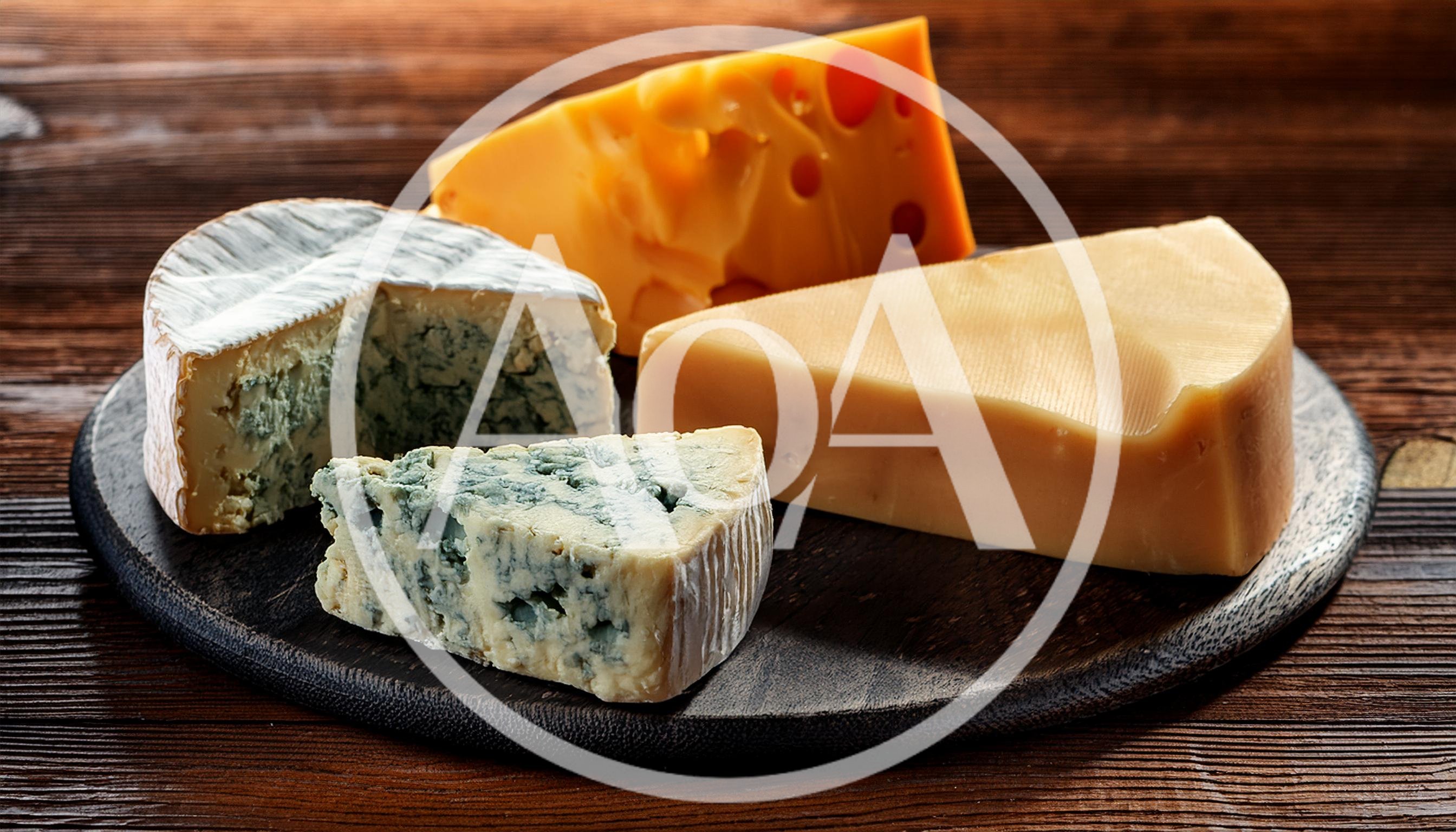 Assorted Cheese Varieties on a Wooden Serving Board