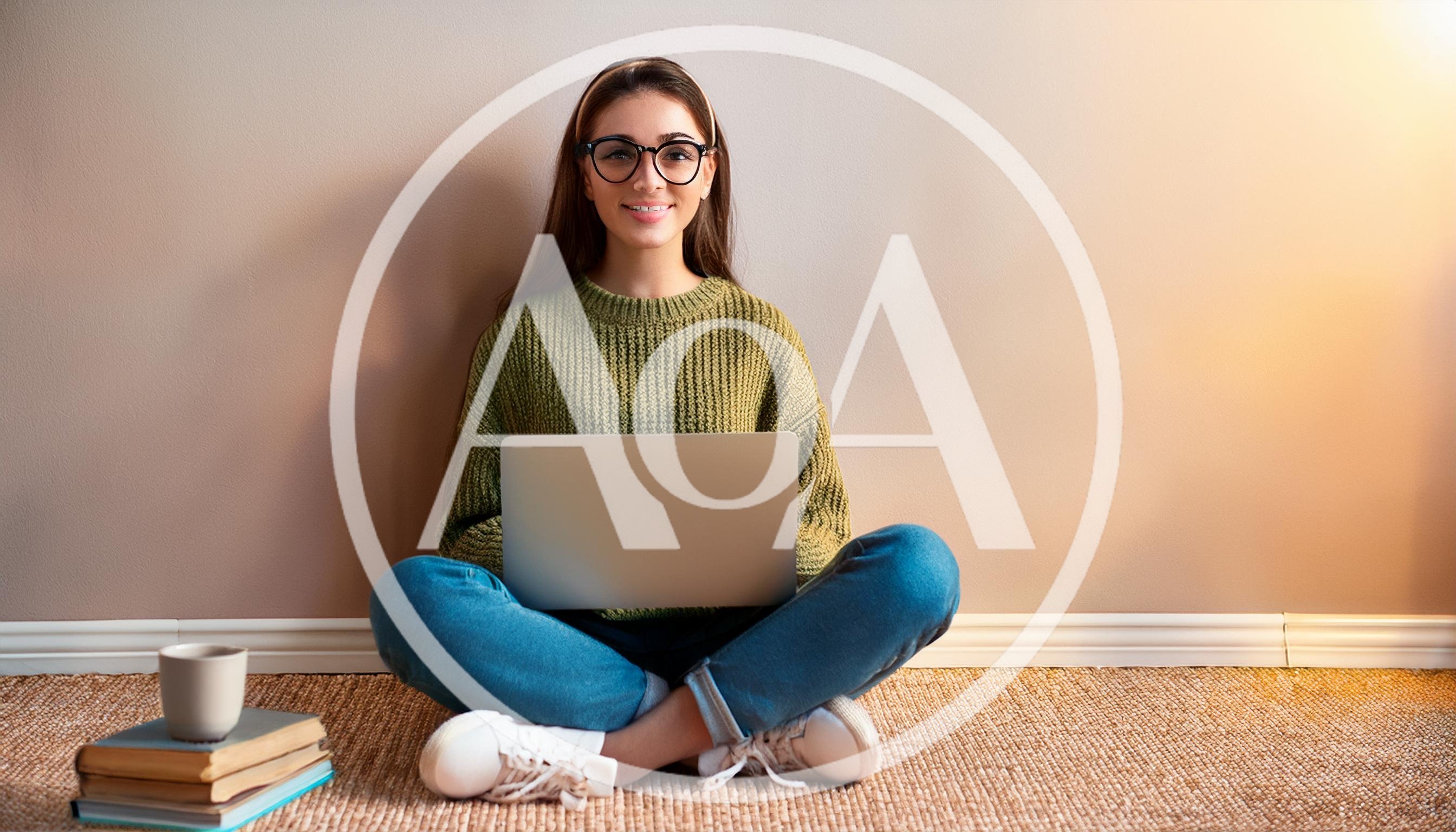Young Woman Sitting On Floor Using Laptop
