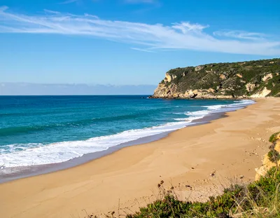 Scenic Sandy Beach With Rocky Coastal Cliffs