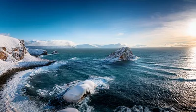 Snow Covered Coastal Cliffs And Sea Stacks In Iceland