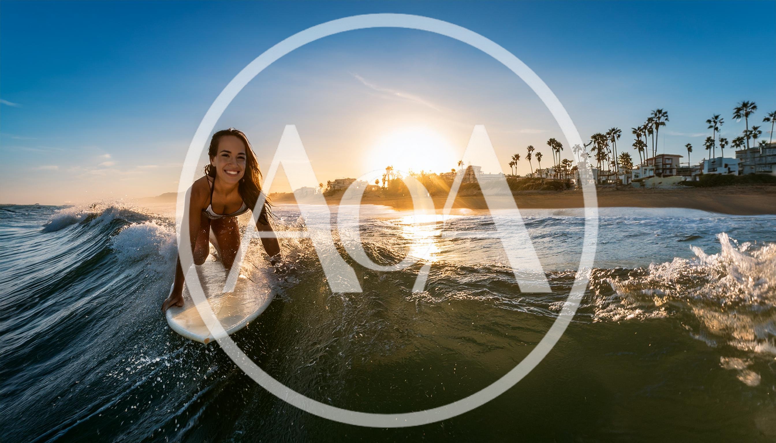 Young Woman Surfing On A Wave At Sunset
