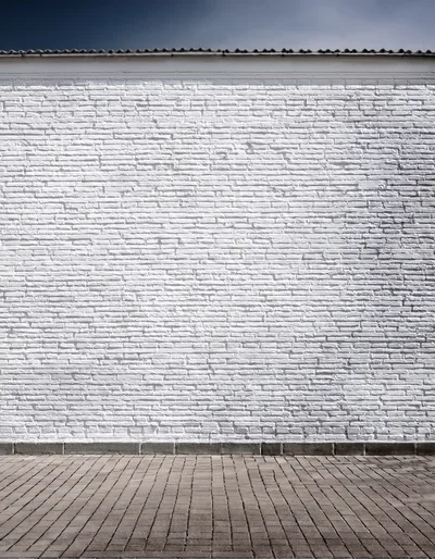 White Brick Wall With Paved Ground