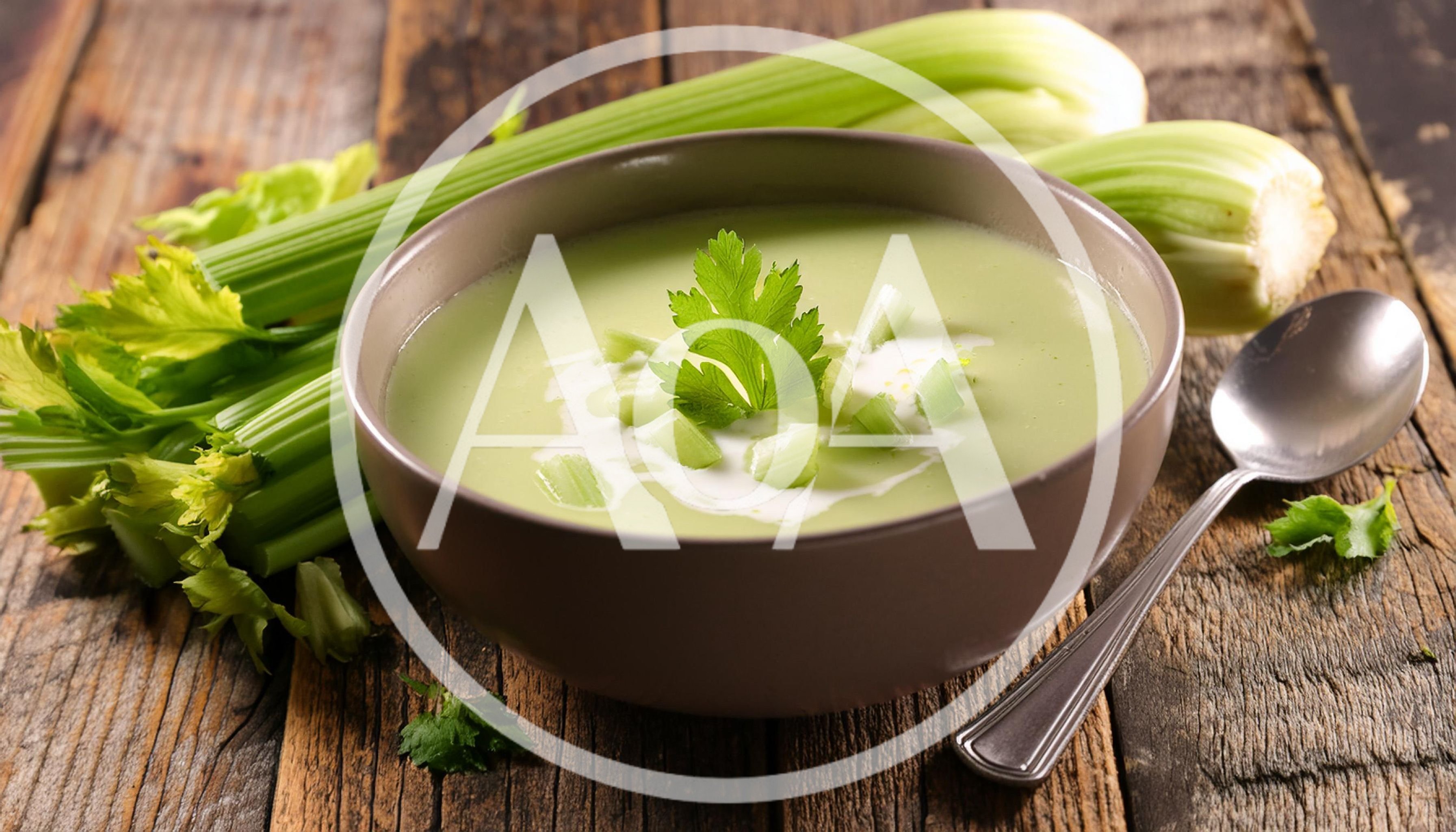 Bowl Of Creamy Celery Soup On Rustic Wooden Table