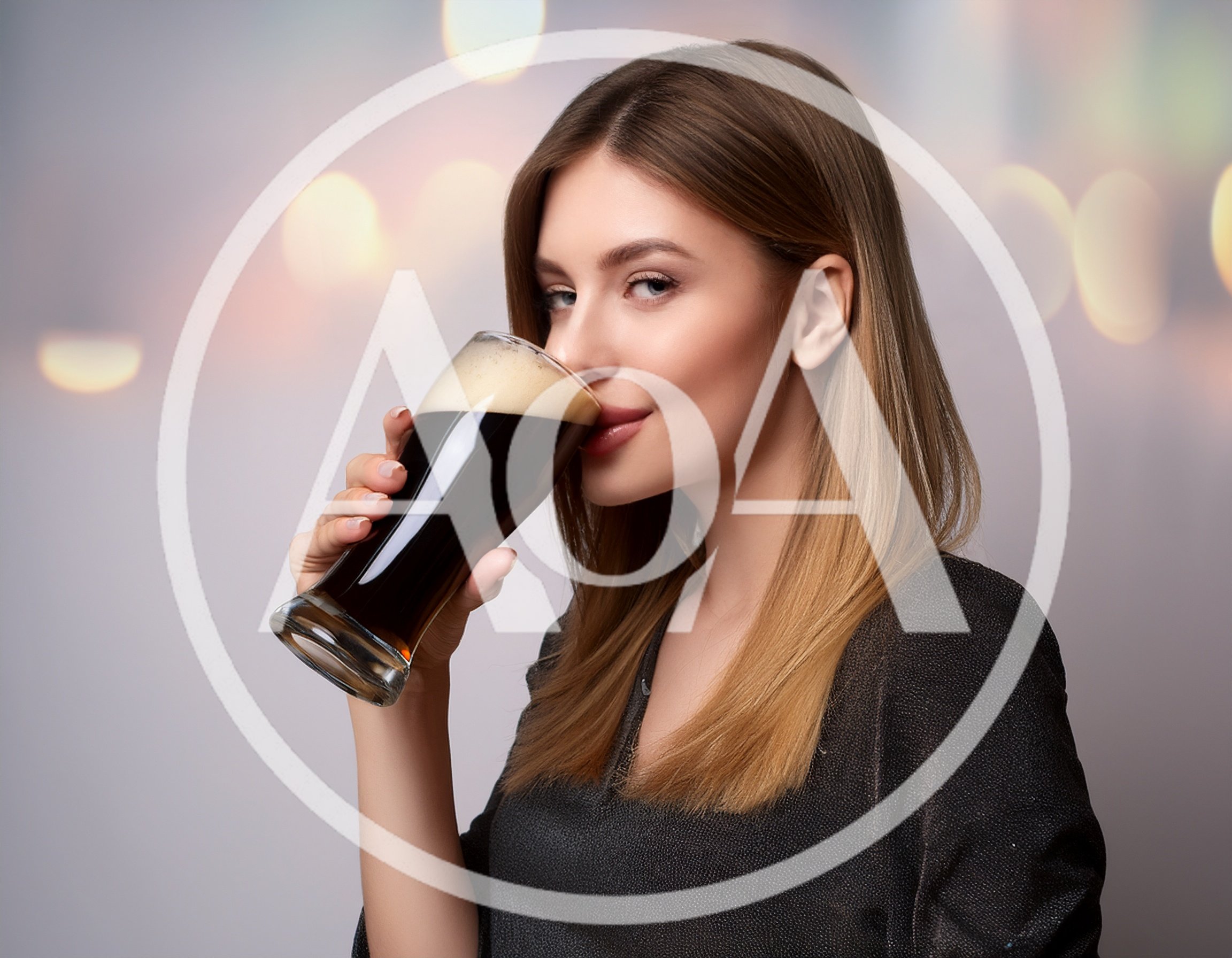 Young Woman Drinking Dark Beer From A Glass