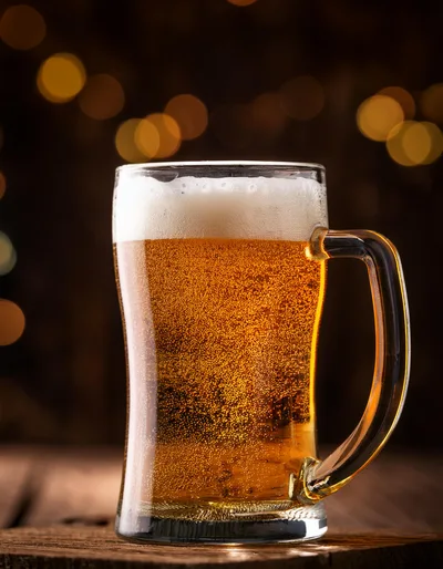 Glass Mug Of Golden Beer With Frothy Head