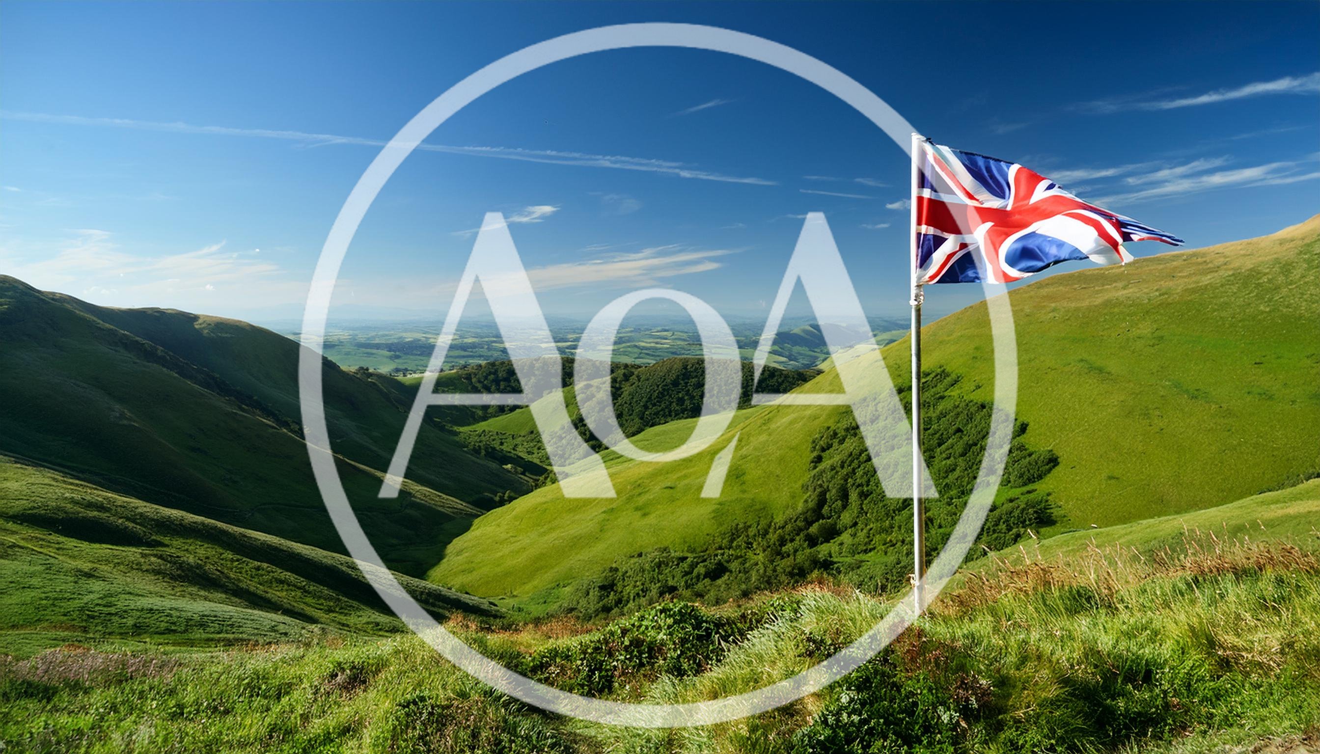 British Flag Flying Over Rolling Green Hills