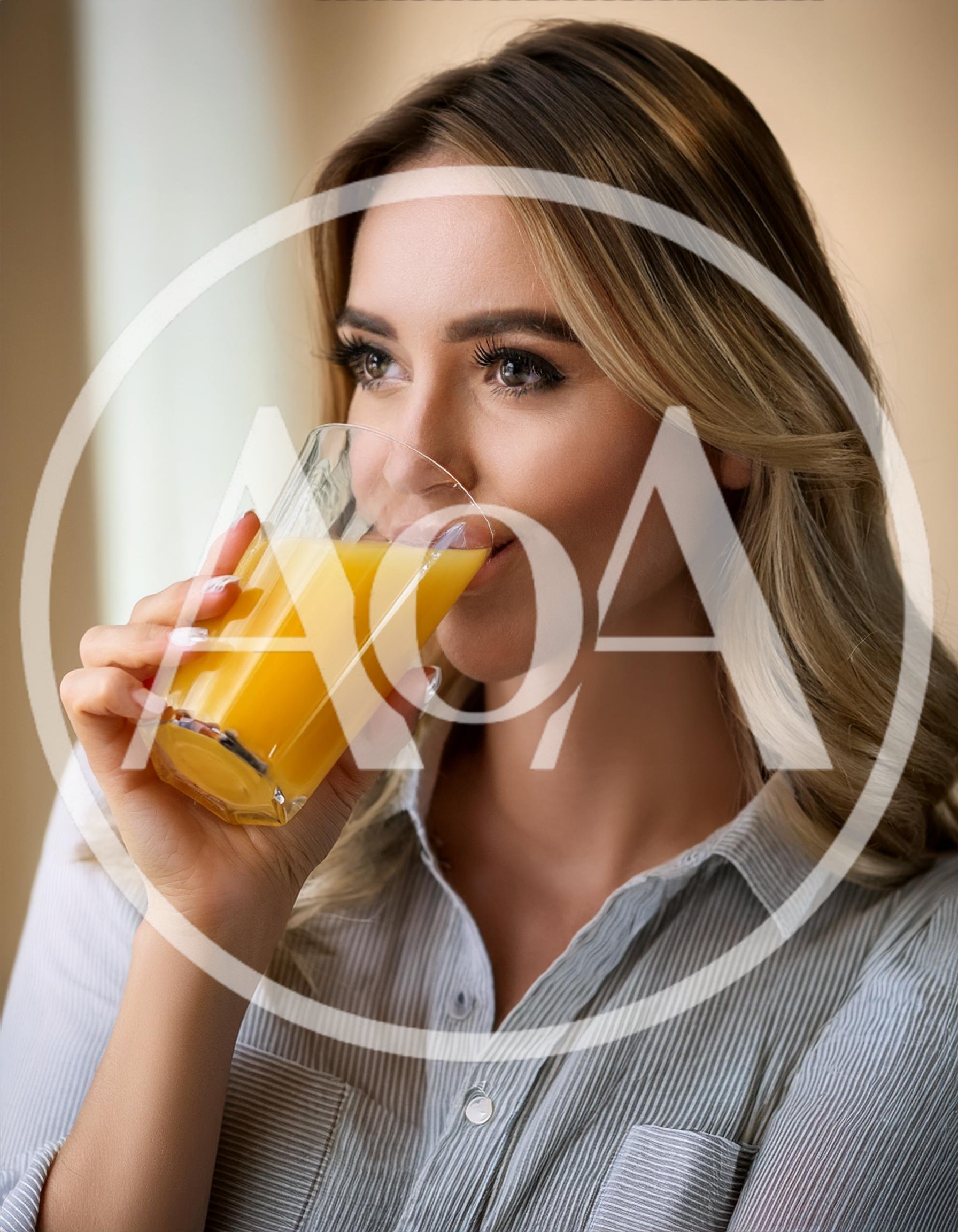 Young Woman Drinking Fresh Orange Juice