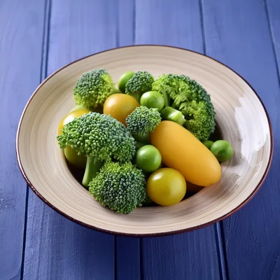 Fresh Broccoli And Yellow Tomatoes In A Ceramic Bowl