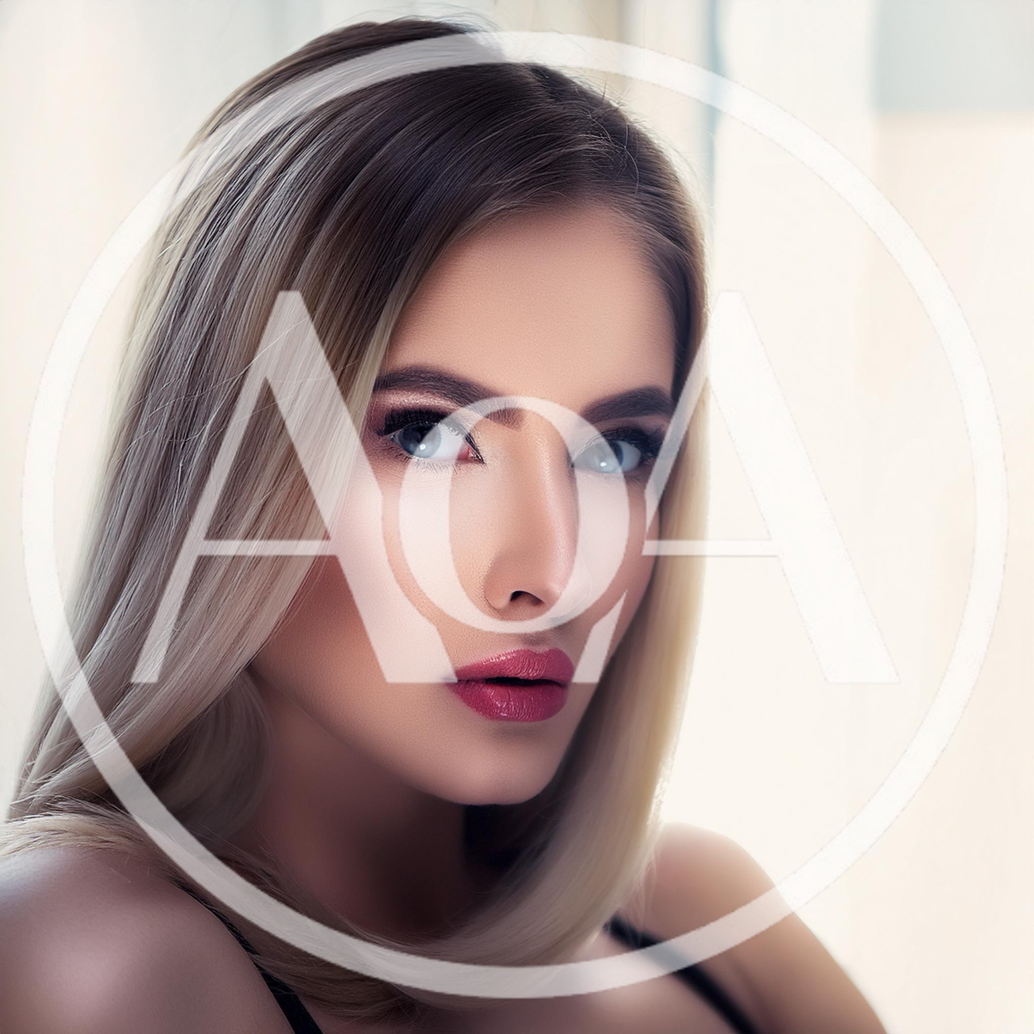 Portrait Of A Beautiful Blonde Woman With Blue Eyes