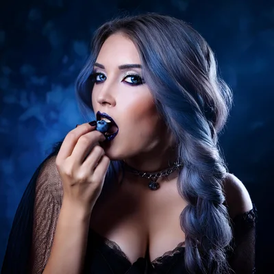 Gothic Woman Eating A Fresh Blueberry