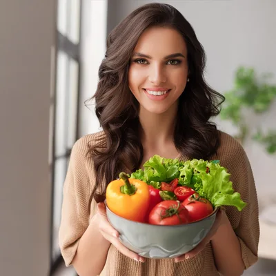 Smiling Woman Holding A Bowl Of Fresh Vegetables