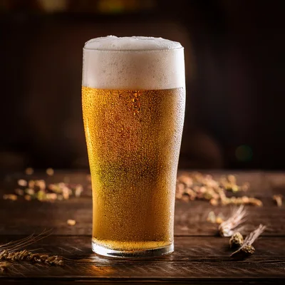 Cold Glass Of Golden Beer On Wooden Table