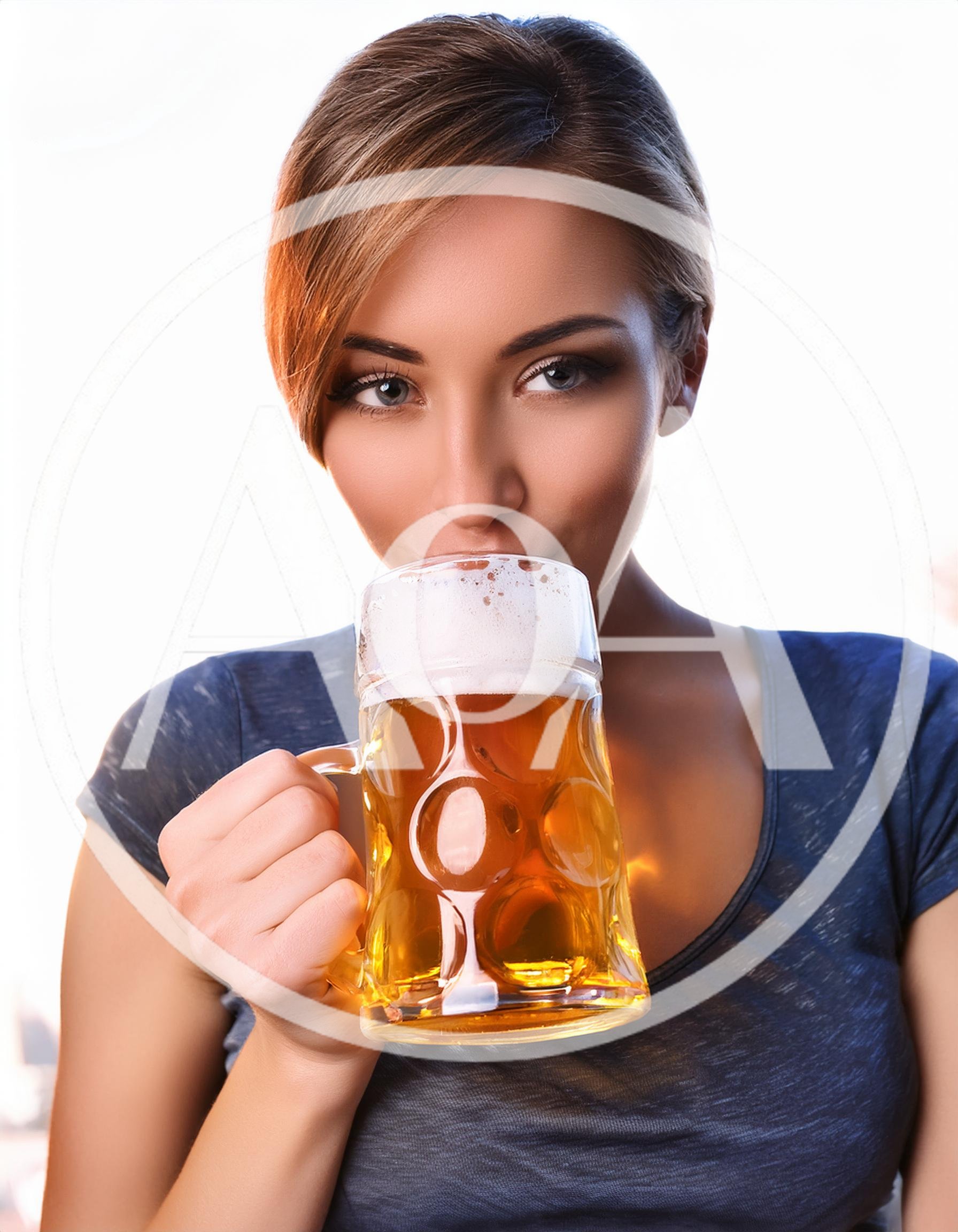 Young Woman Drinking Beer From A Glass Mug