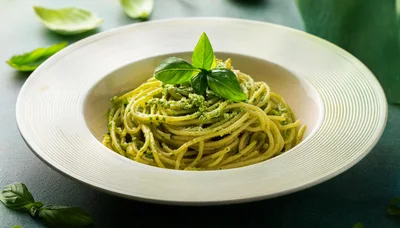 Spaghetti With Pesto Sauce In A White Bowl