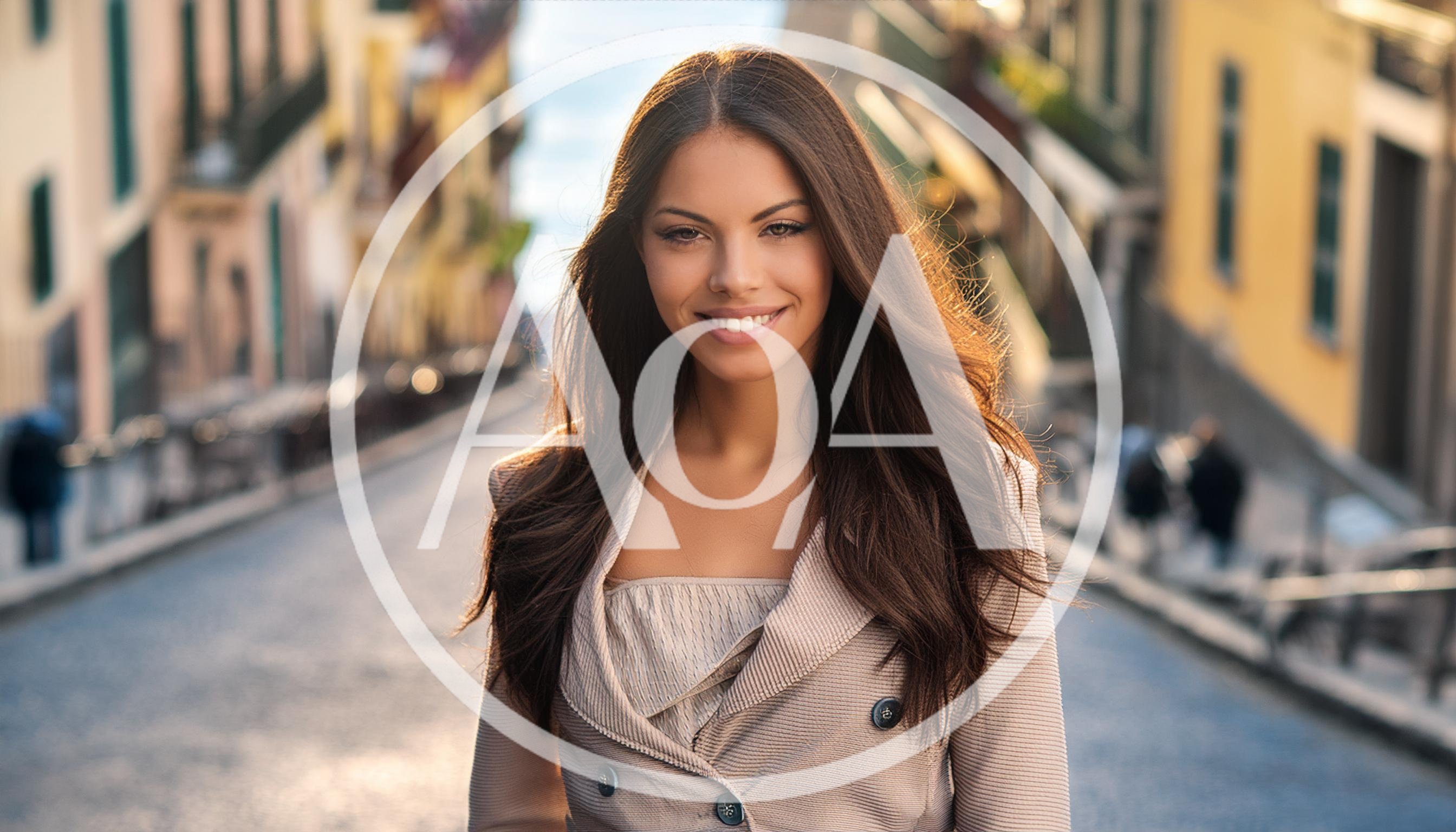 Young Woman Smiling On A Sunny European Street