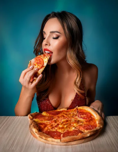 Beautiful Woman Eating A Slice Of Pizza
