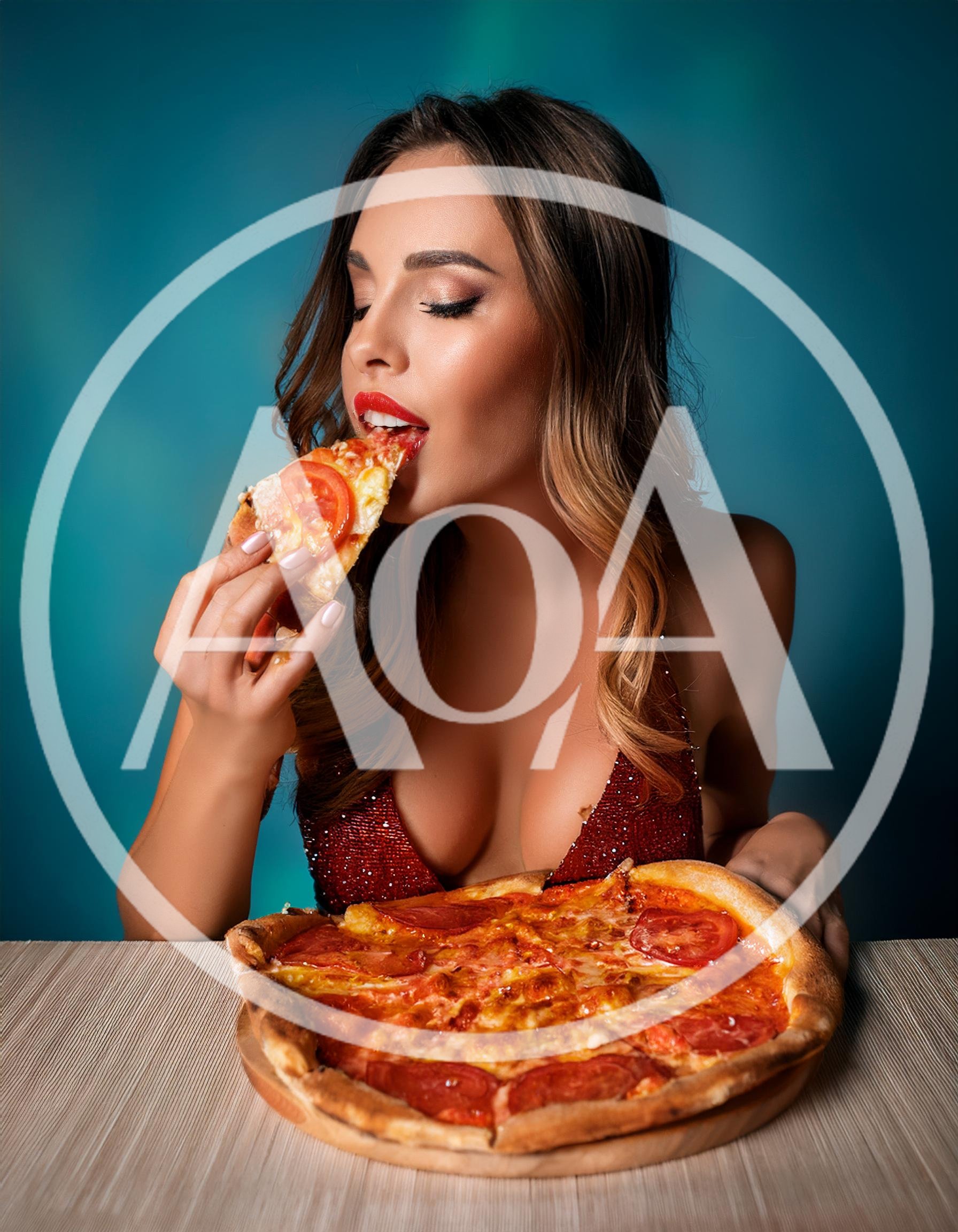 Beautiful Woman Eating A Slice Of Pizza