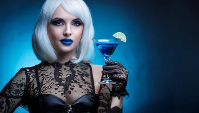Woman With White Hair Holding A Blue Cocktail