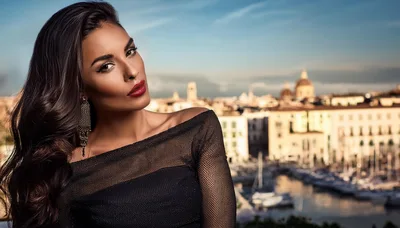 Glamorous Woman Posing Against A Mediterranean Cityscape
