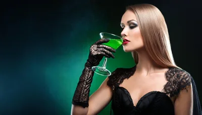 Elegant Woman Drinking Green Cocktail In Lace Gloves
