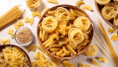 Assorted Dry Pasta Varieties On Wooden Surface