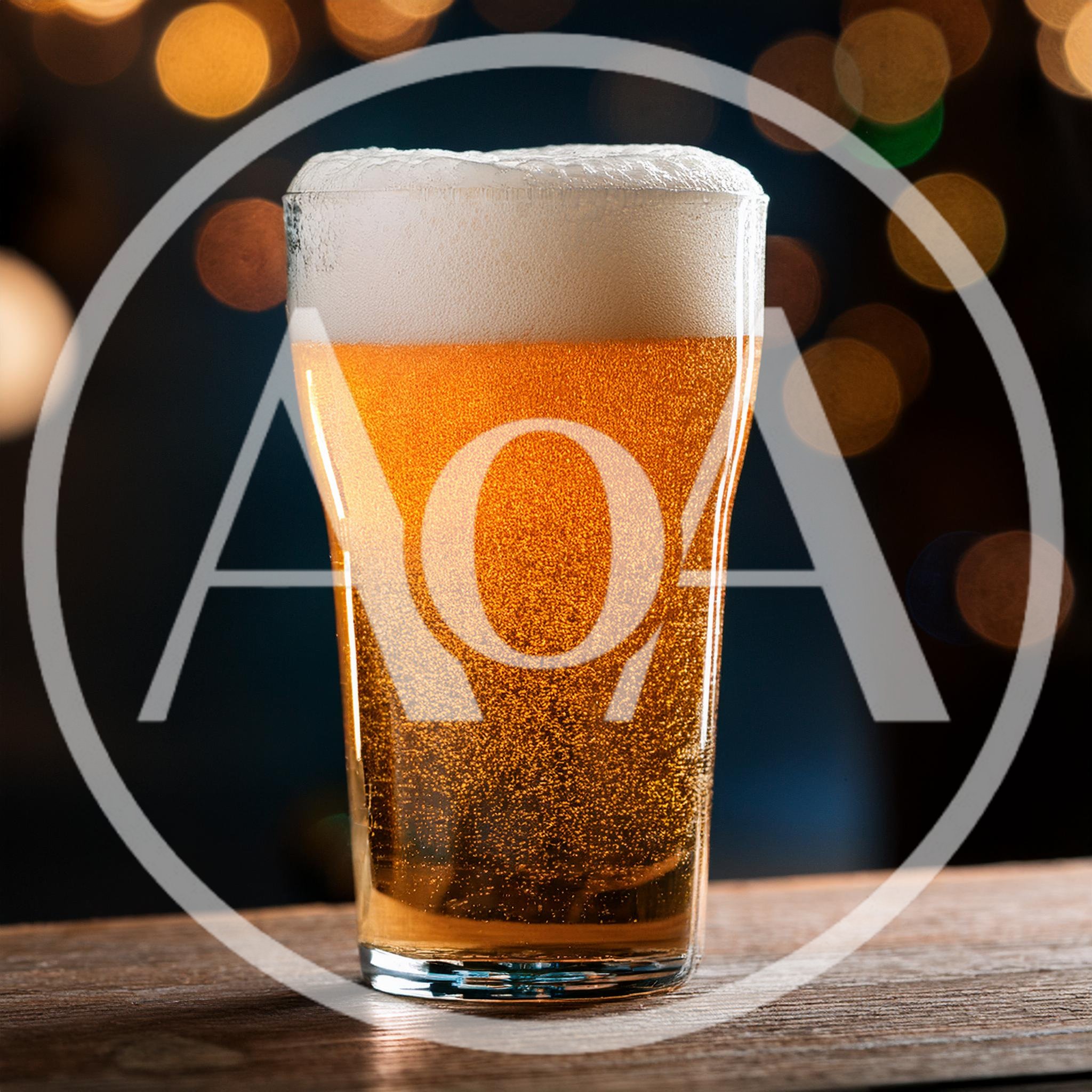 Glass Of Golden Beer With Frothy Head On Wooden Table