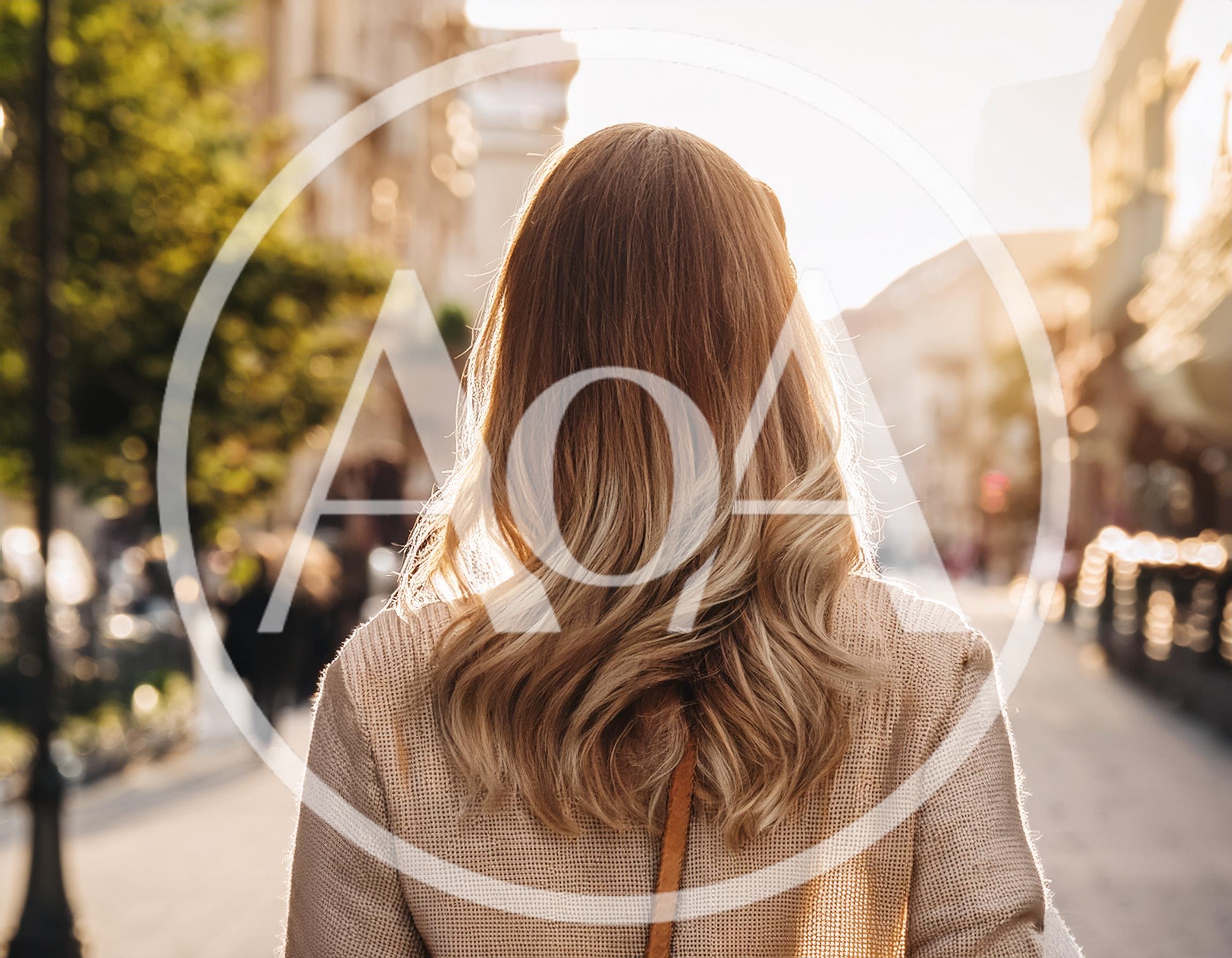 Woman With Blonde Hair Walking Down City Street